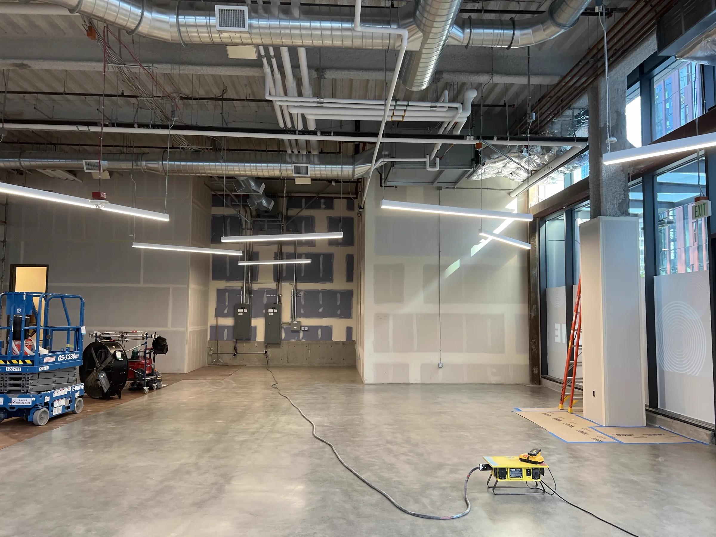 Mid-construction with scissor lift inside studio