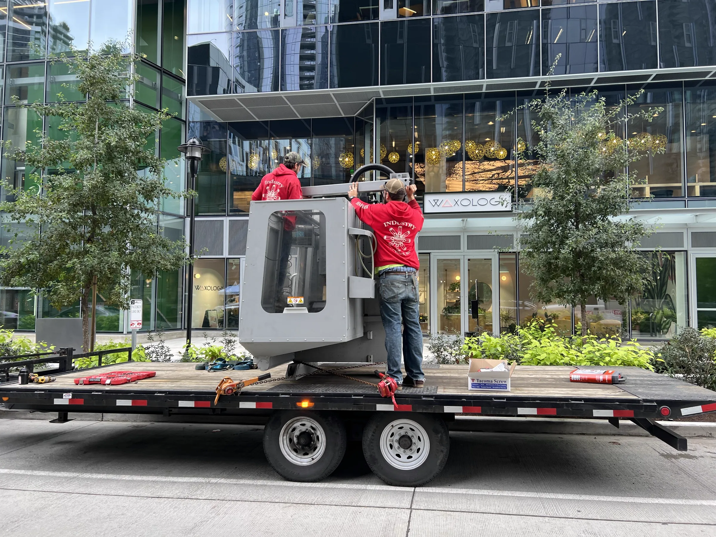 CNC machine on flatbed truck arriving at South Lake Union