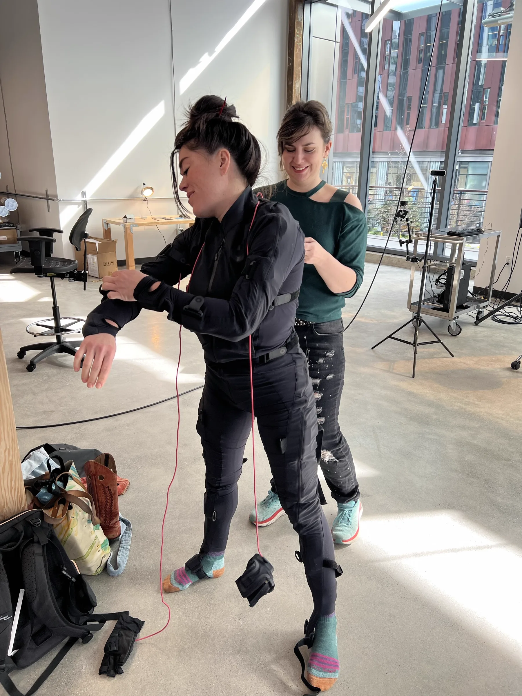 Two visitors working at workbench