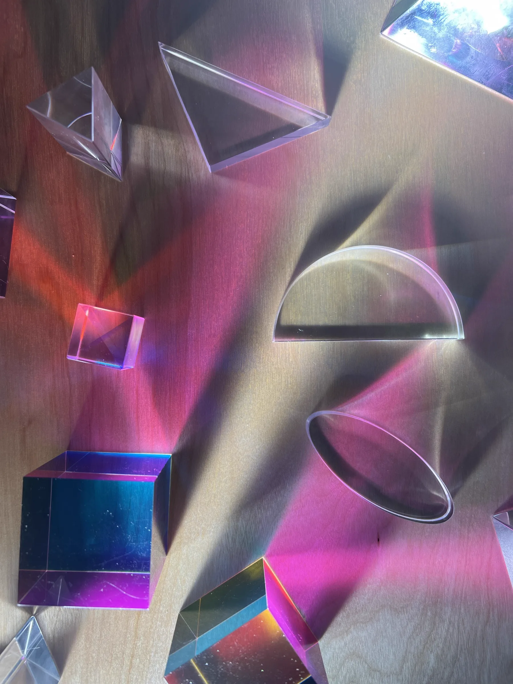 Iridescent acrylic prisms on workbench